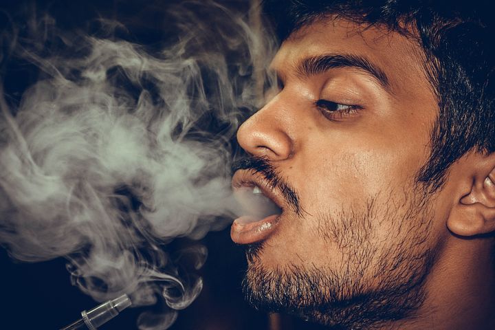 Man with smoke coming out from his mouth